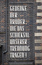 The inscription 'Remember the brothers who bear the fate of our separation!' on a brick house on the market square in Bremen commemorates the German division of 1949