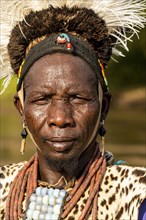 Man from the Toposa tribe posing in his traditional warrior costume