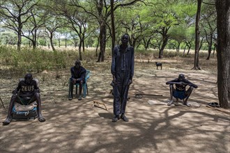 Olders of the Toposa tribe have a reunion under the trees