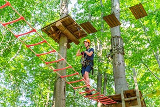 Boy climbing in the climbing forest and high ropes course