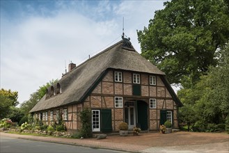 Thatched half-timbered house and summer garden