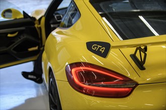 Detail of rear spoiler of Porsche Cayman GT4 with logo GT4 in pitbox