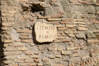 Sign from Temple of Romulus on Roman brick wall