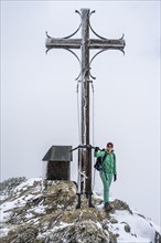 Hiker at the summit cross