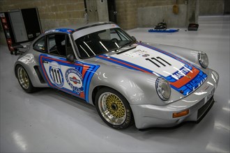 Historic race car Porsche 911 RSR from 1974 in the pits of Circuit de Spa-Francorchamps