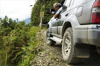 Driver checks the road in an off-road vehicle