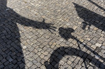 Shadow of the hand of a bicycle thief