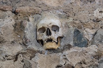 Stone structure embedded with human skulls