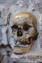 Stone structure embedded with human skulls