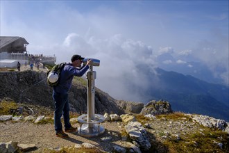 Hiker with telescope at the summit of Lagazuoi