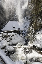 Mountain stream and mill with snow and ice