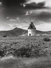Windmill in barren landscape