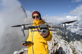 Young woman holding a drone with camera