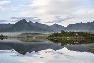 Mountains reflected in fjord near Laukvik