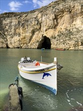 Moored excursion boat without tourists in inland sea of Gozo