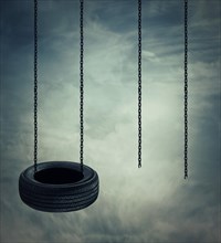 Two swings on a cloudy sky background
