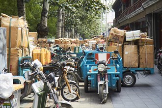 Tricycle delivery vehicles packed with parcels