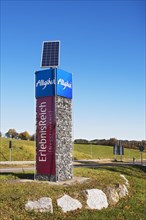 Column with advertising for Allgaeu and Nesselwang with solar panel
