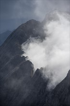 Mountain ridge between clouds