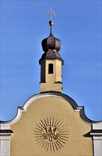 Baroque monogram of the Virgin Mary on the facade of a church