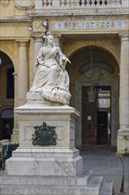 Marble statue of Queen Victoria in front of entrance to National Library of Malta building