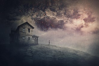 Creepy storm scene with scary lightnings over a ghost land with a haunted house and a person phantom standing under rain