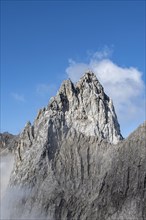 Rocky mountain peak with summit cross