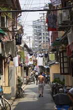 Street in a hutong with hanging laundry above the street