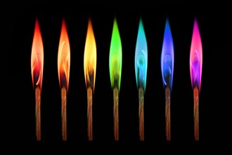 Matches burning in the rainbow colors flames on black background