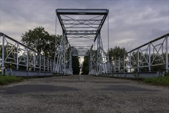A steel lift bridge from 1895 over the Tina River in the village of Jezioro