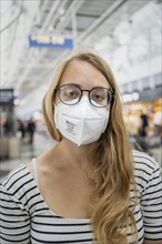 Young woman wearing glasses and an FFP-2 mask