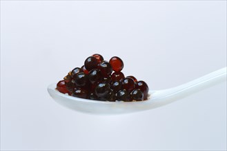 Aceto pearls in spoon