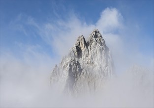 Rocky mountain peak between clouds