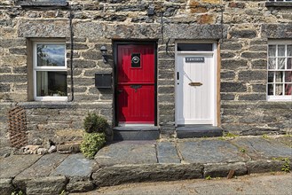 Traditional stone house with two different coloured doors