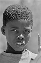 South African boy looks sceptically at the camera