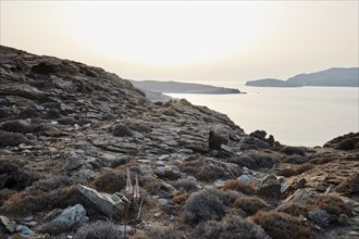 Coast of Tinos at the narrowest point to Andros in the unusual white sunset light