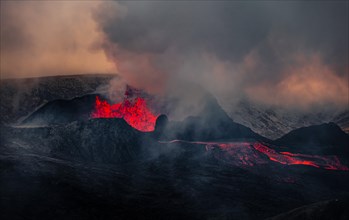 Erupting volcano with lava fountains and lava field