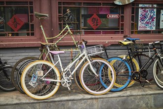 Bicycles on the wall of a house in Jianchang Hutong