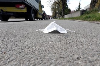 FFP2 mask lies on the cycle path