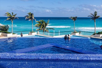 Swimming pool over the turquoise waters of Cancun