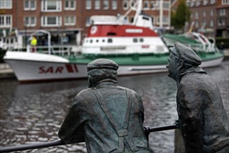 Bronze statues of dolphin spitters at the Ratsdelft