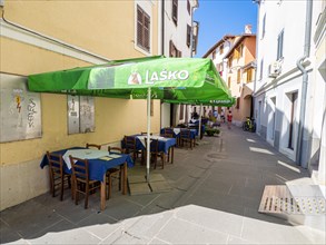 Restaurant tables in an alley in the old town of Izola