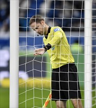 Referee Linesman checks goal net for hole or damage