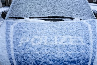 The snowed-in bonnet of a police car