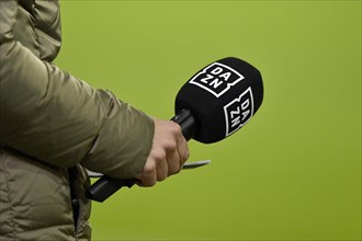Presenter holding microphone with DAZN logo