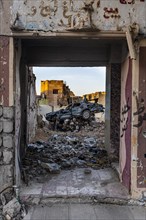 Demolished car in a destroyed house from ISIS