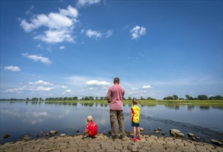 Family man with his sons fishing on the river Oder