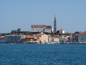 View from the sea to the harbour entrance of Piran