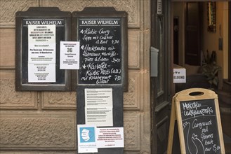 Behavioural advice during the pandemic in front of a restaurant 2021