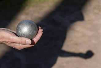 Man's hand holding petanque ball